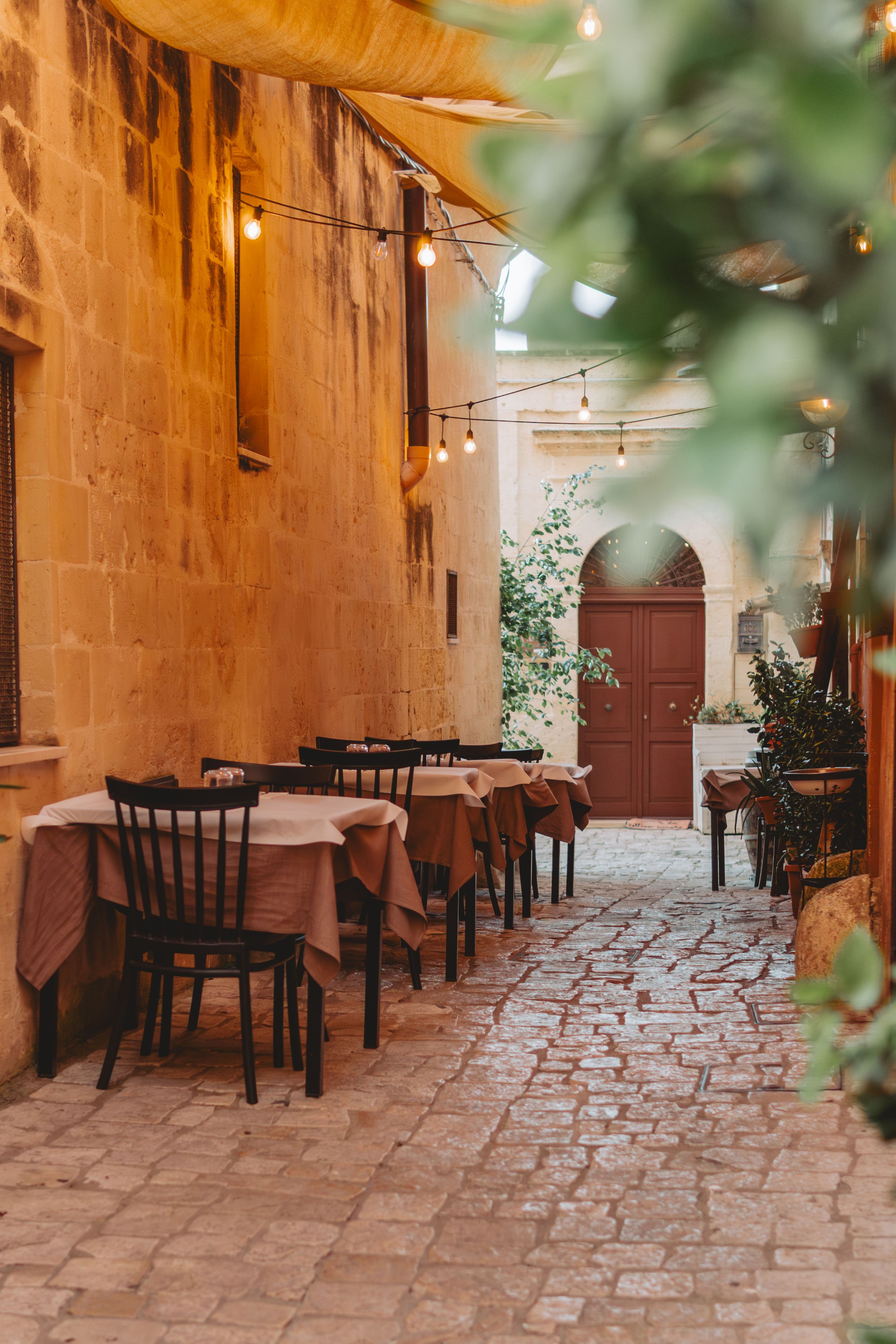 Outdoor alley dining with string lights